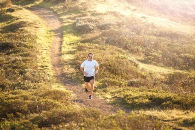 Man running the trails in the country